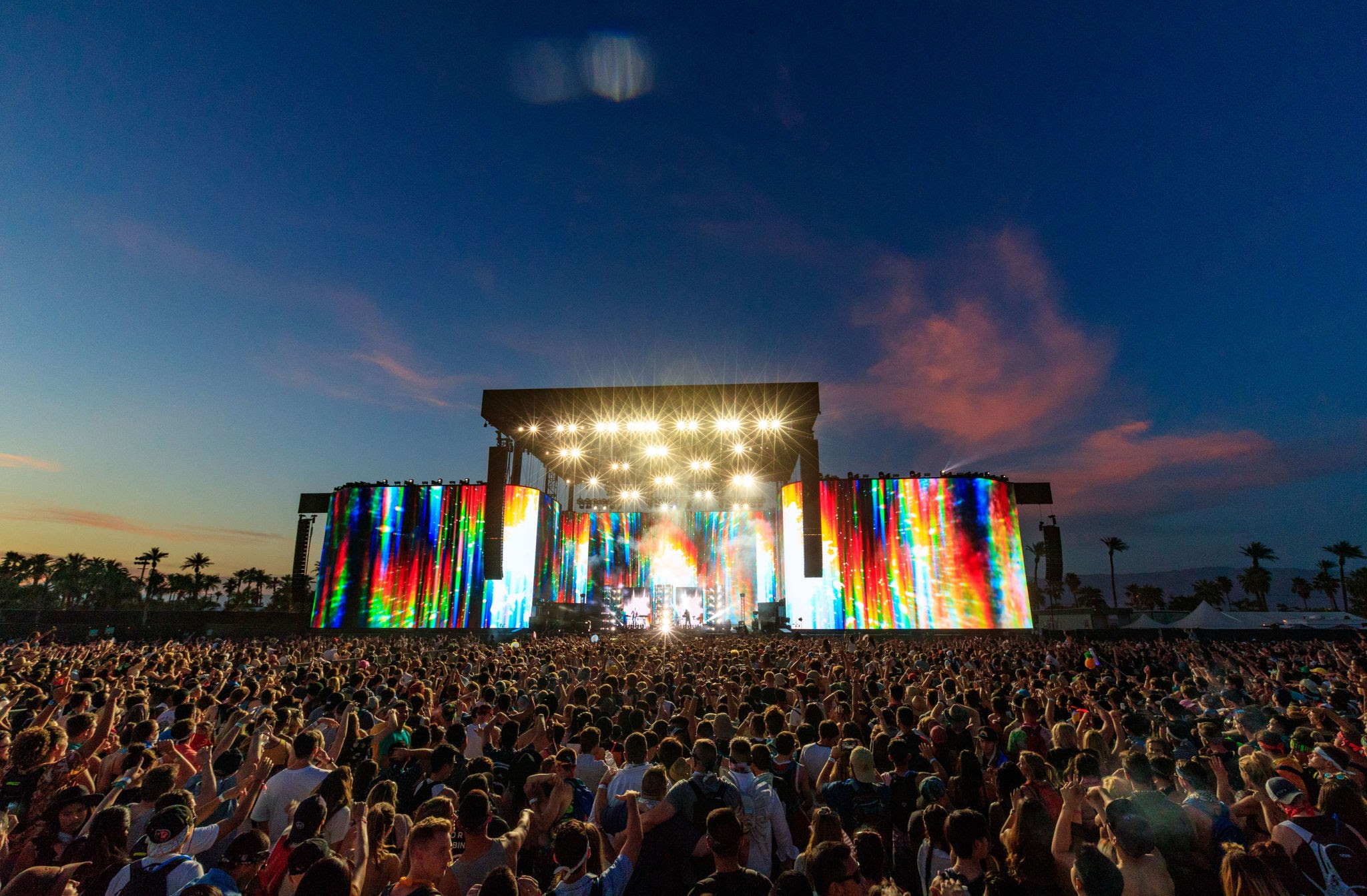 Desert festival crowd at sunset