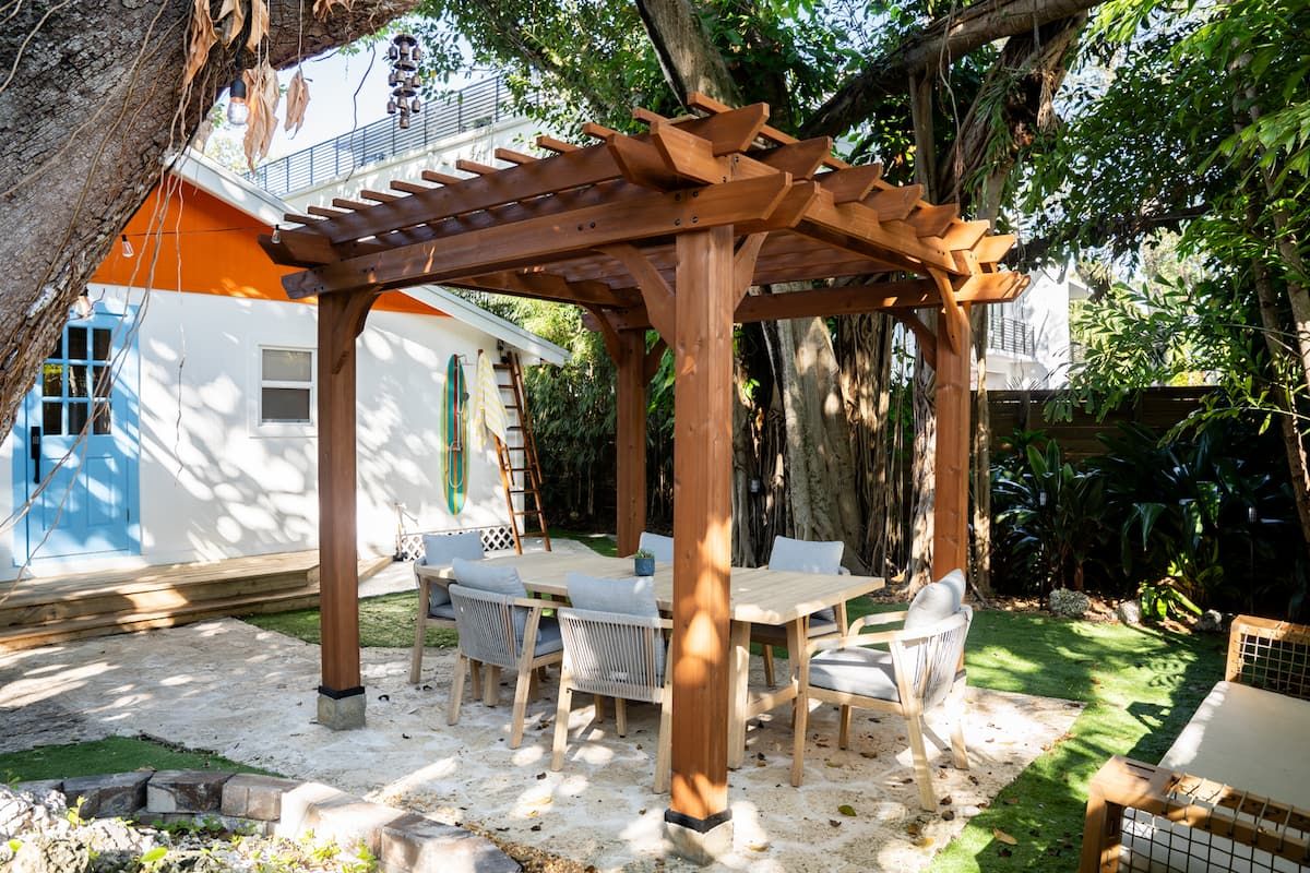 Image may contain Architecture Building House Housing Porch Patio Wood Pergola Outdoors Chair and Furniture
