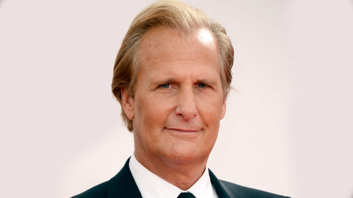Portrait of a middle-aged man with blonde hair in a dark suit and white shirt, looking at the camera with a slight smile.