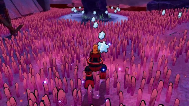 Robot explorer navigating a pink alien field, collecting glowing blue crystals in a cavernous landscape.