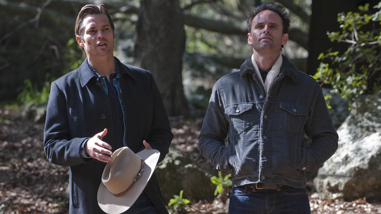 Raylan Givens (Timothy Olyphant) and Boyd Crowder (Walton Goggins) standing together outside in Justified