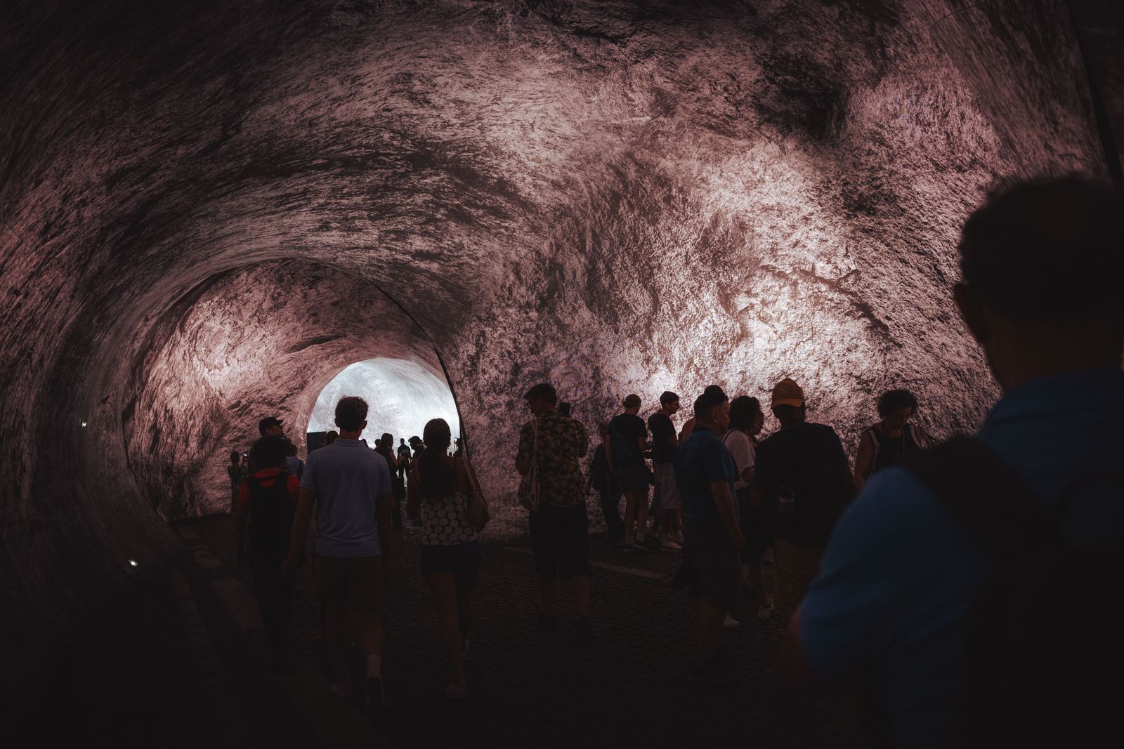 Image may contain Cave Nature Outdoors Adult Person Accessories Bag Handbag Clothing Hat and Tunnel