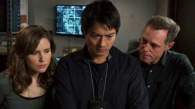 Erin Lindsay, Sheldon Jin, and Hank Voight standing next to each other looking at a computer in Chicago P.D.