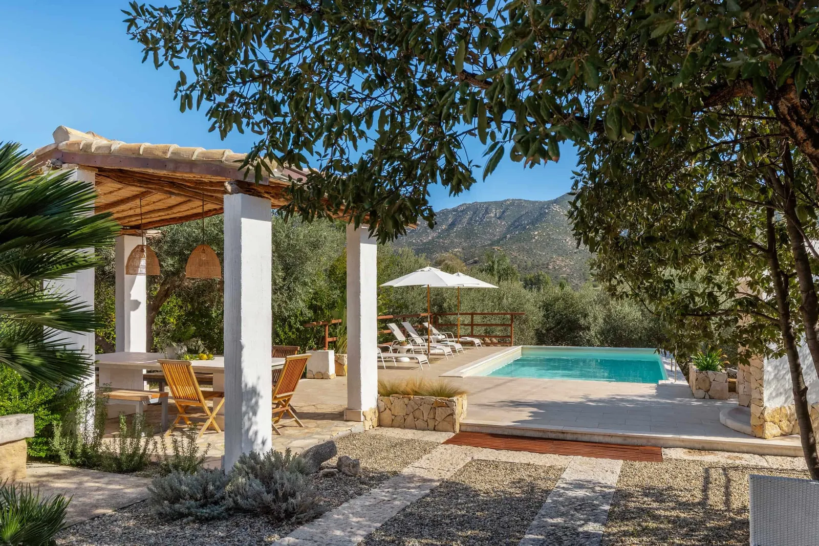 Image may contain Architecture Building House Housing Villa Pool Water Patio Porch Swimming Pool and Chair