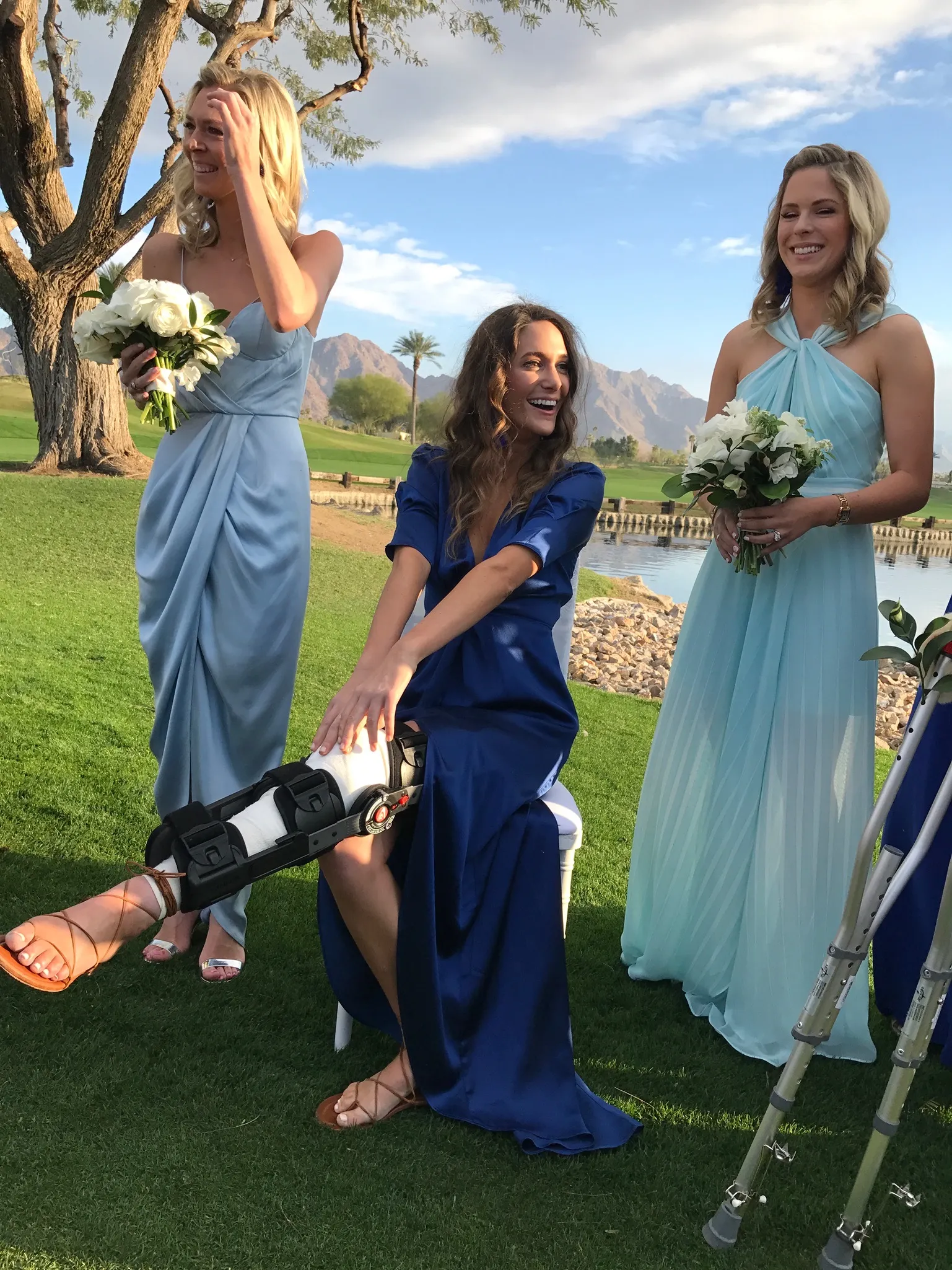 Image may contain Grass Plant Clothing Dress Person Photobombing Photography Adult Wedding Formal Wear and Flower