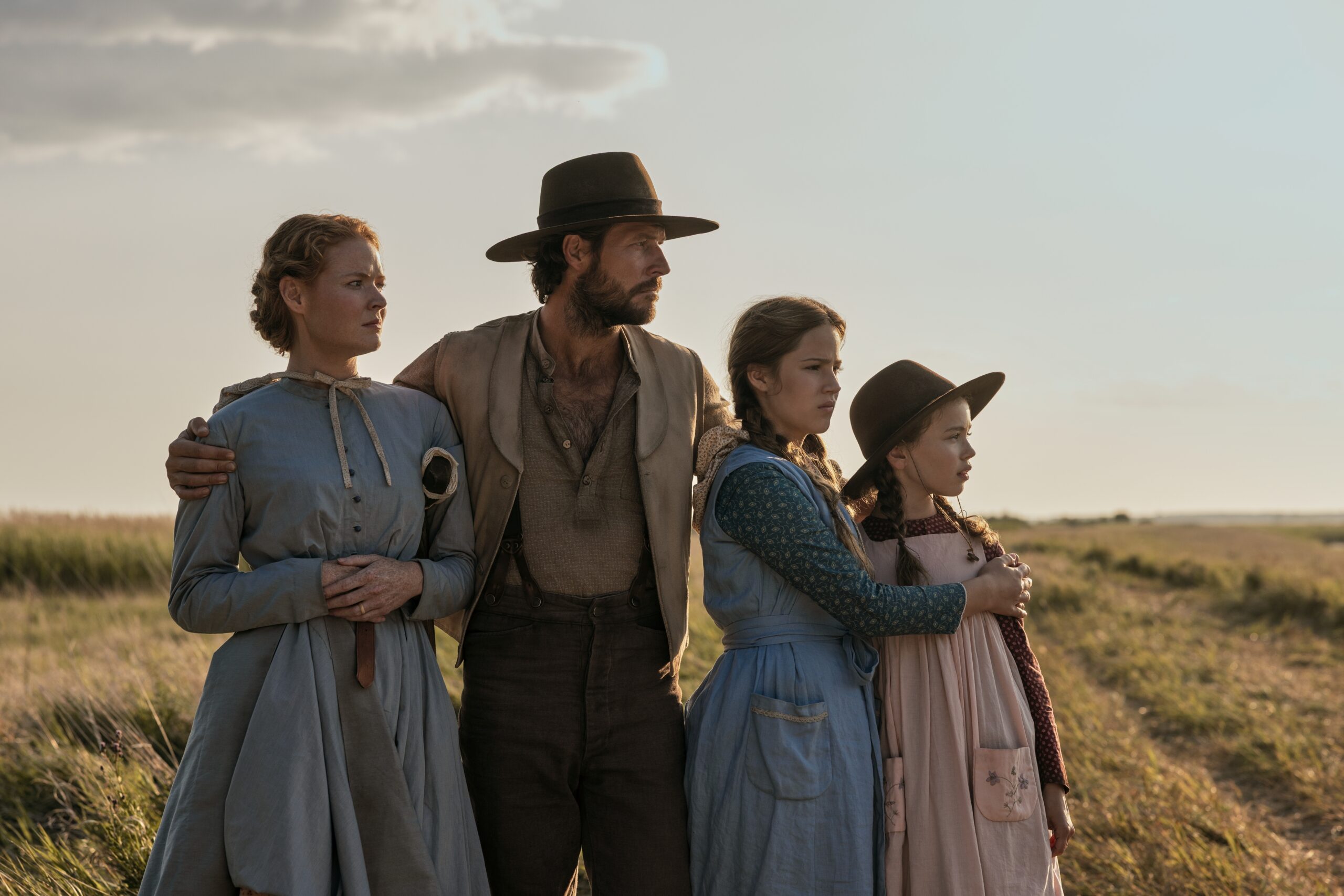 L-R: Crosby Fitzgerald as Caroline Ingalls, Luke Bracey as Charles Ingalls, Skywalker Hughes as Mary Ingalls, Alice Halsey as Laura Ingalls in 'Little House on the Prairie'