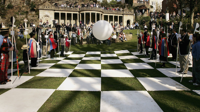 The ominous white orb, Rover, looms over a human chess board in the Village on classic sci-fi series, The Prisoner.