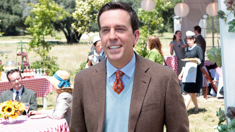 Ed Helms as Andy, smiling at a garden party in The Office.