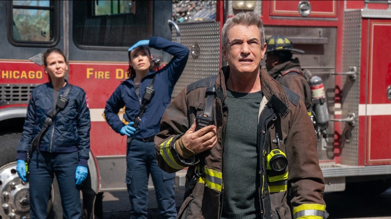 Firefighters in front of fire truck looking up in "Chicago Fire"