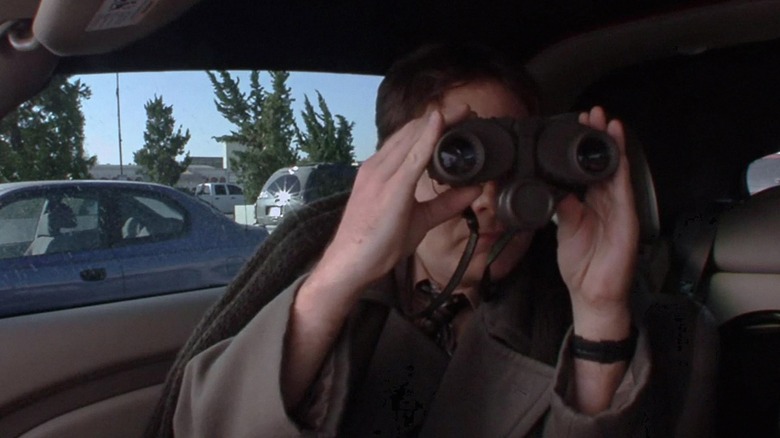 Rainn Wilson as Dwight Schrute, using binoculars in The Office.