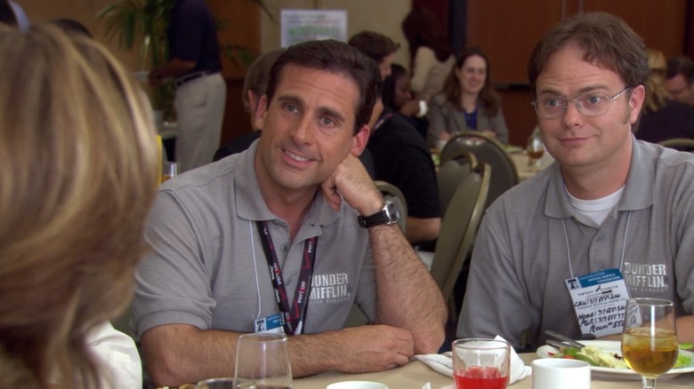 Michael and Dwight smile at Jan at a convention in The Office.