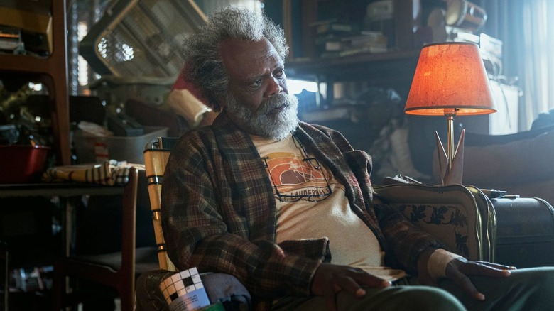 Samuel L. Jackson as Ptolemy Grey, sitting in a cluttered room in The Last Days of Ptolemy Grey.