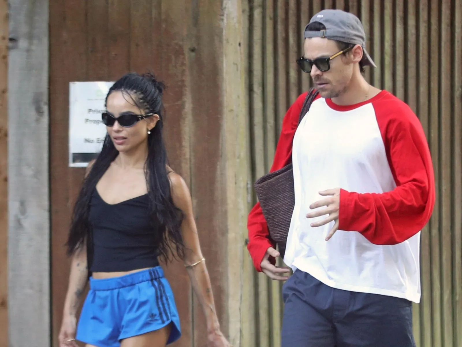 Image may contain Harry Styles Zoë Kravitz Adult Person Accessories Sunglasses Clothing Hat Teen and Shorts