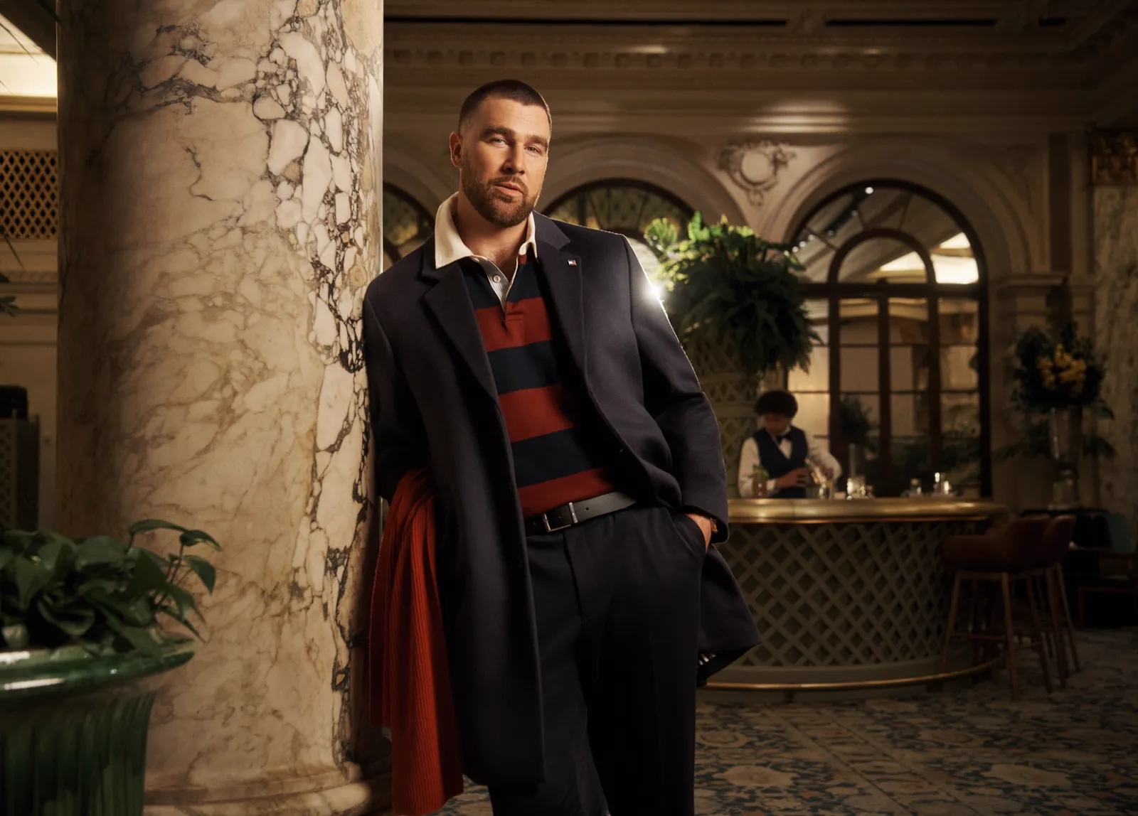 Image may contain Travis Kelce Clothing Coat Blazer Jacket Formal Wear Suit Face Head Person and Photography