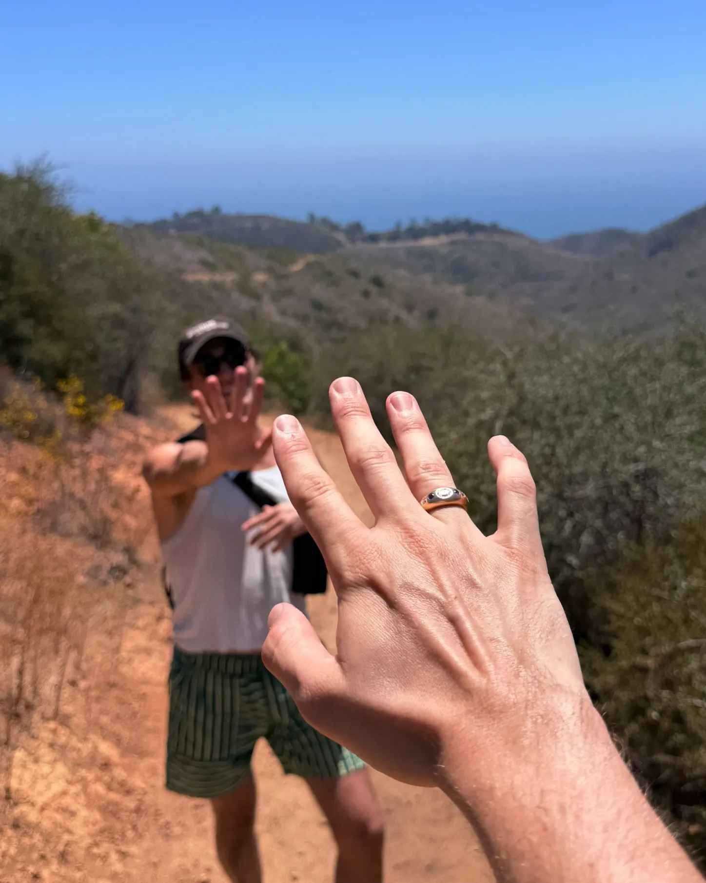Image may contain Body Part Finger Hand Person Clothing Shorts Adult Accessories Jewelry Ring and Plant