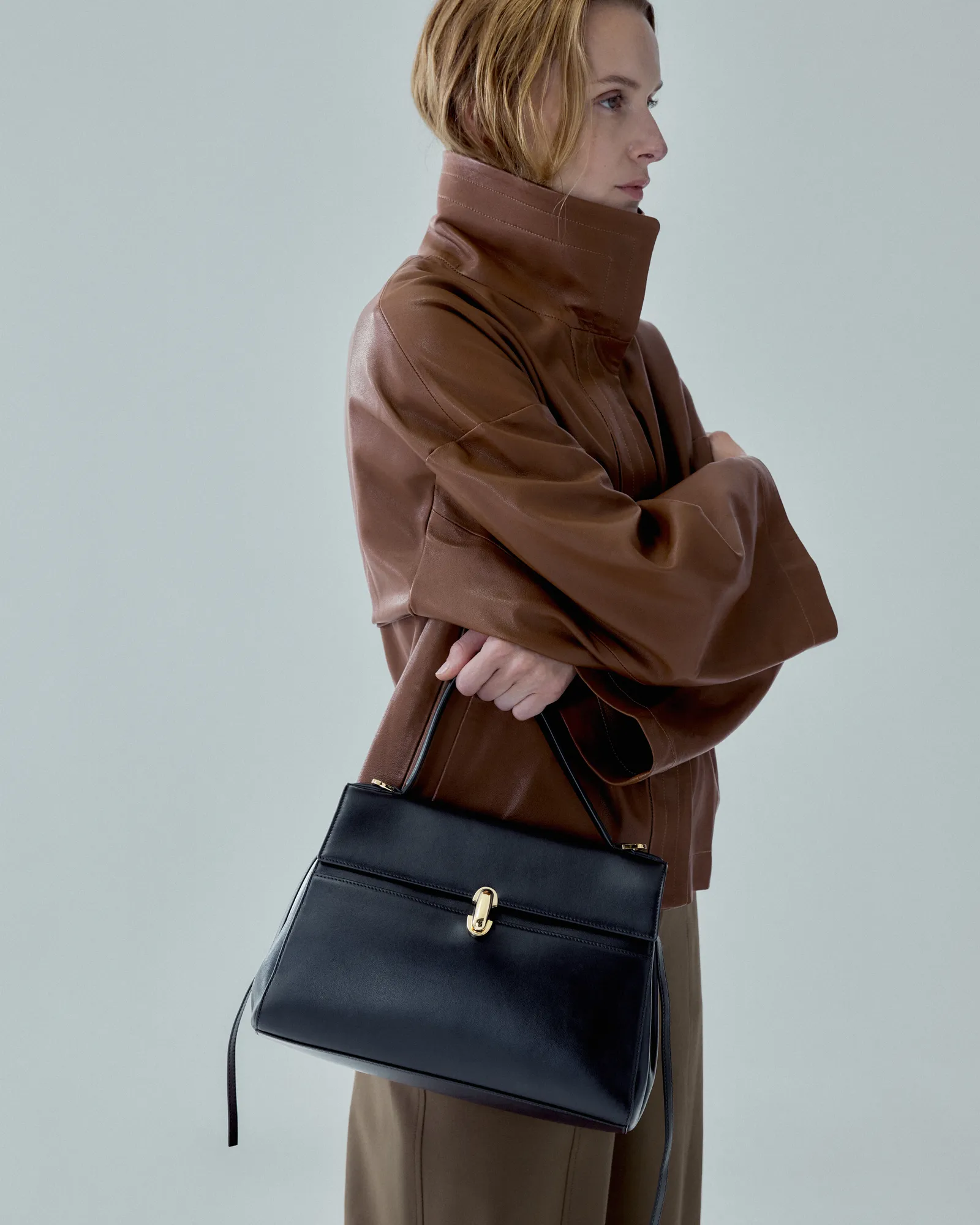 Image may contain Accessories Bag Handbag Clothing Coat Purse Adult Person and Jacket