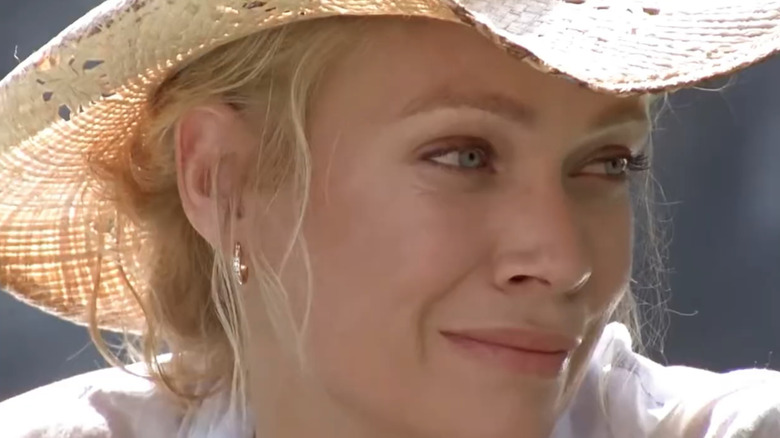 Laurie Holden as Andrea Harrison wears a cowboy hat in The Walking Dead