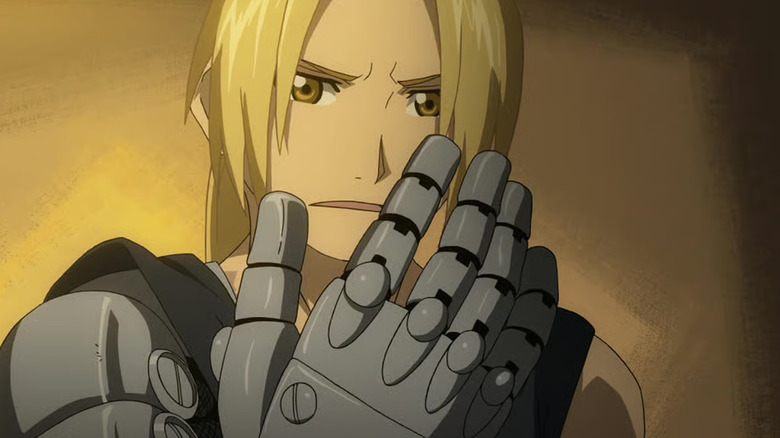 Edward Elric looking at his metal arm in Fullmetal Alchemist: Brotherhood