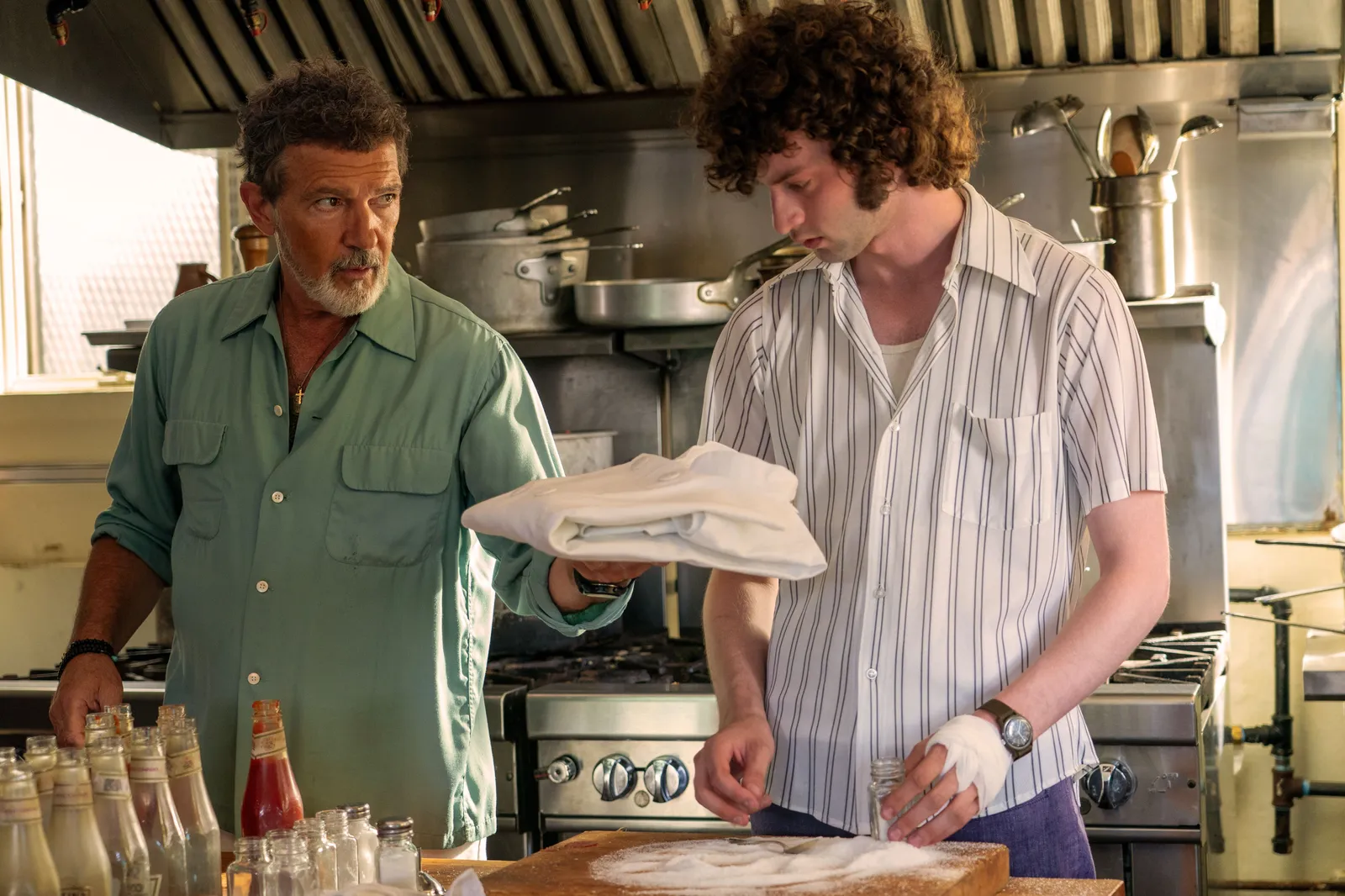 Image may contain Nathan Fake Antonio Banderas Adult Person Clothing Glove Head Teen Face and Baby