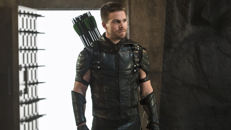 Stephen Amell as Oliver Queen wearing a green and black costume in Arrow