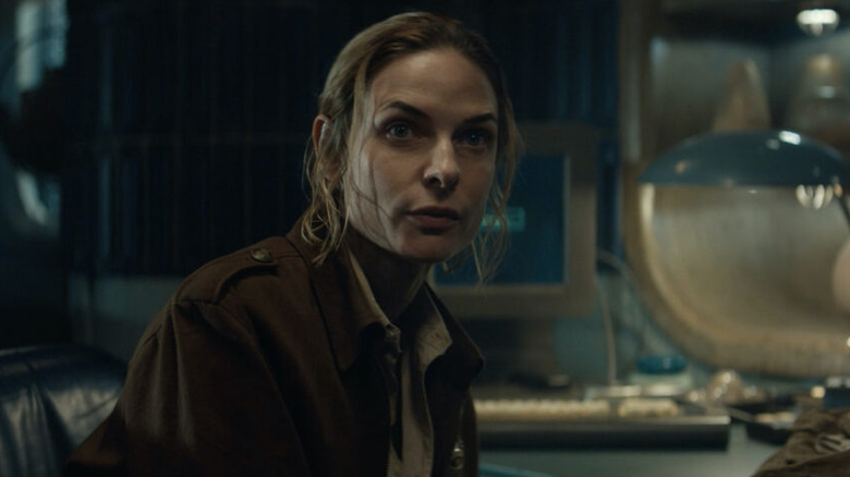 Rebecca Ferguson as Juliette sitting at a desk in Silo