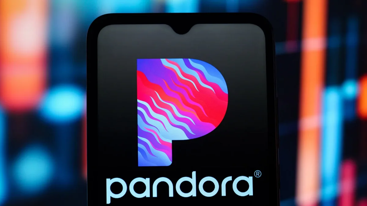 Smartphone screen displaying the Pandora logo against a blurred colorful background.