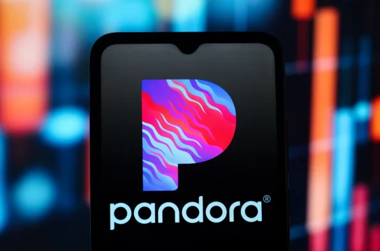 Smartphone screen displaying the Pandora logo against a blurred colorful background.