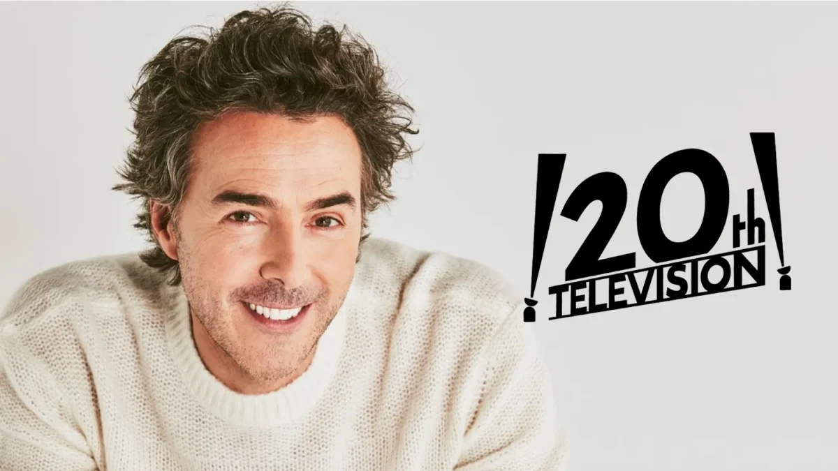 Smiling man in a cream sweater appears beside a black 20th Television logo on a gray background.