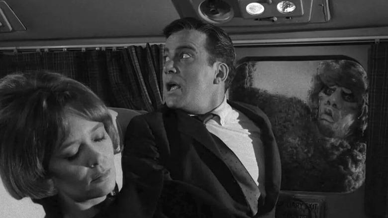 Robert Wilson looks for help as a monster peers through the plane's window in "The Twilight Zone" (1959)