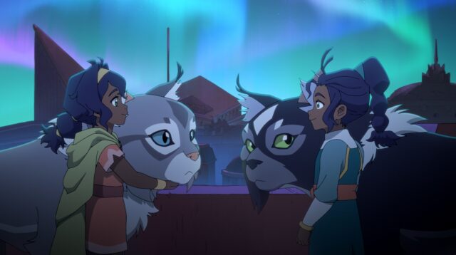 Two animated girls face each other with large cat-like creatures under colorful aurora lights.