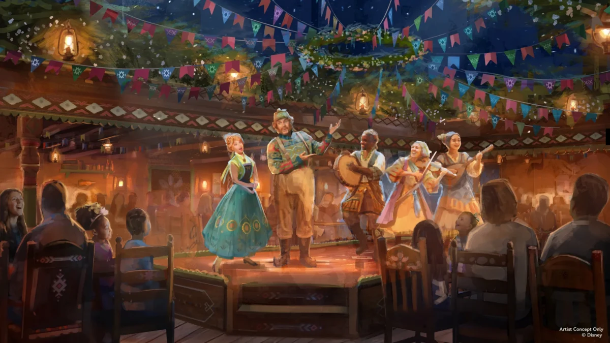 Costumed performers sing and play instruments on a warmly lit stage beneath colorful banners as diners watch.