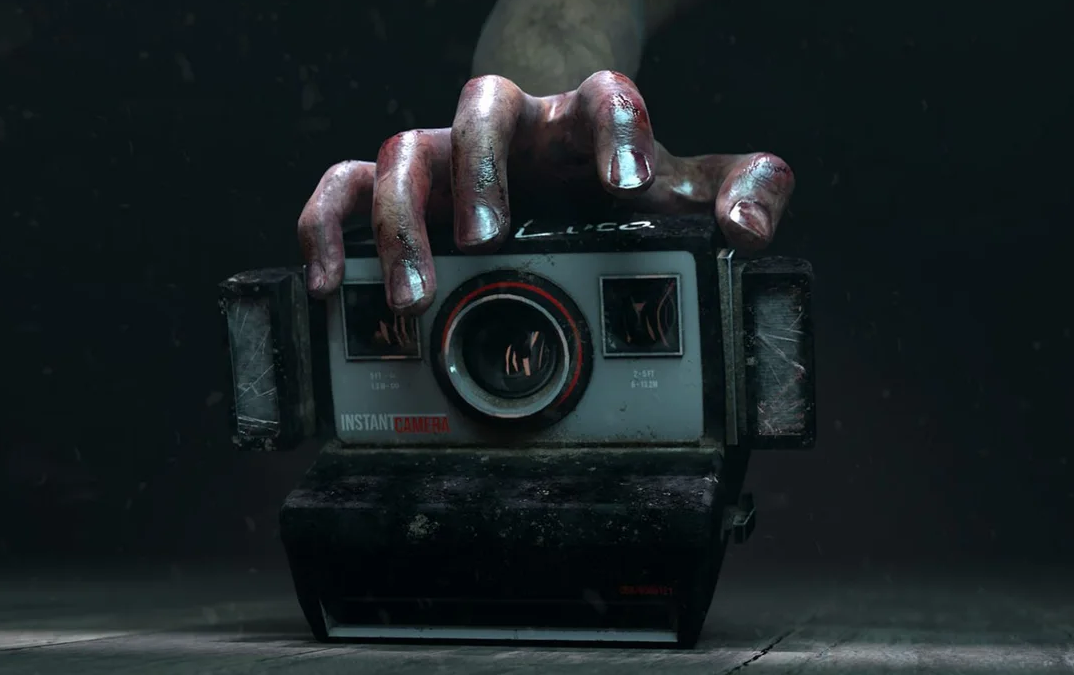 A grimy, bloodstained hand grips an old instant camera against a dark background.