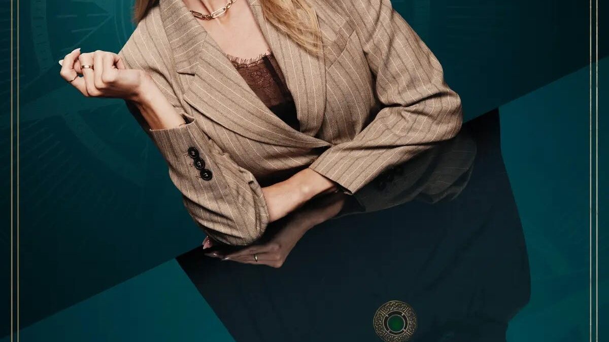 A smiling blonde woman in a tan blazer leans over a reflective surface on a teal promotional poster.