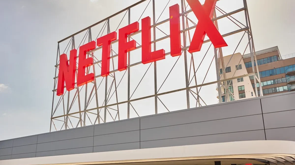 Large red Netflix sign mounted on a metal frame above a building exterior.