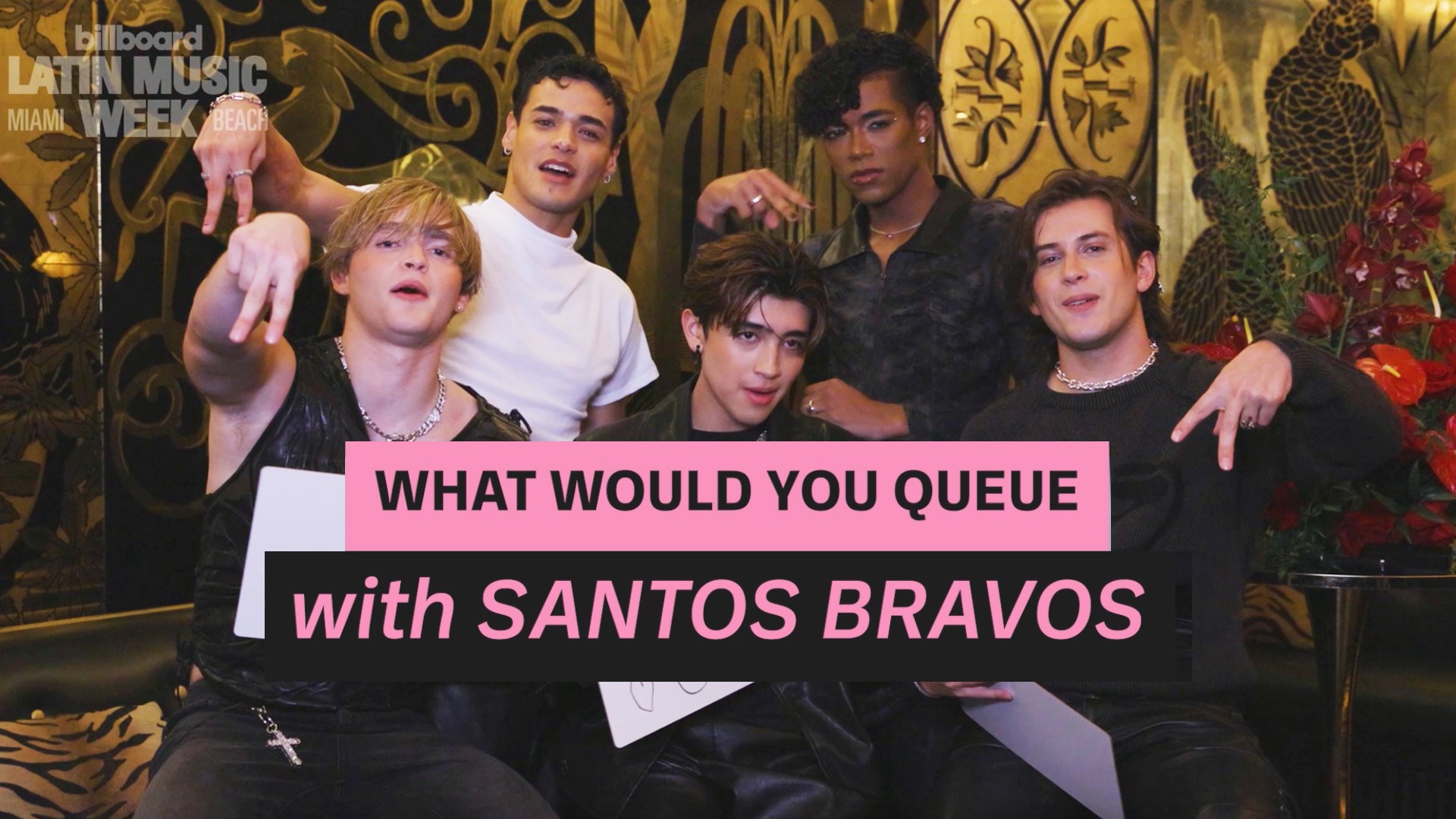 Five young men pose in front of ornate gold wall with graphic reading “What Would You Queue with Santos Bravos.”