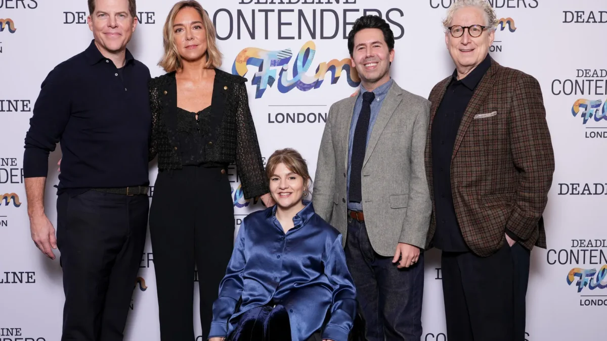 Five adults pose before a Deadline Contenders Film London backdrop, with one seated in a wheelchair.