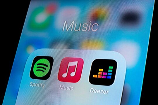In this photo illustration, a Spotify app, Apple Music app and Deezer app are seen displayed on a smartphone.