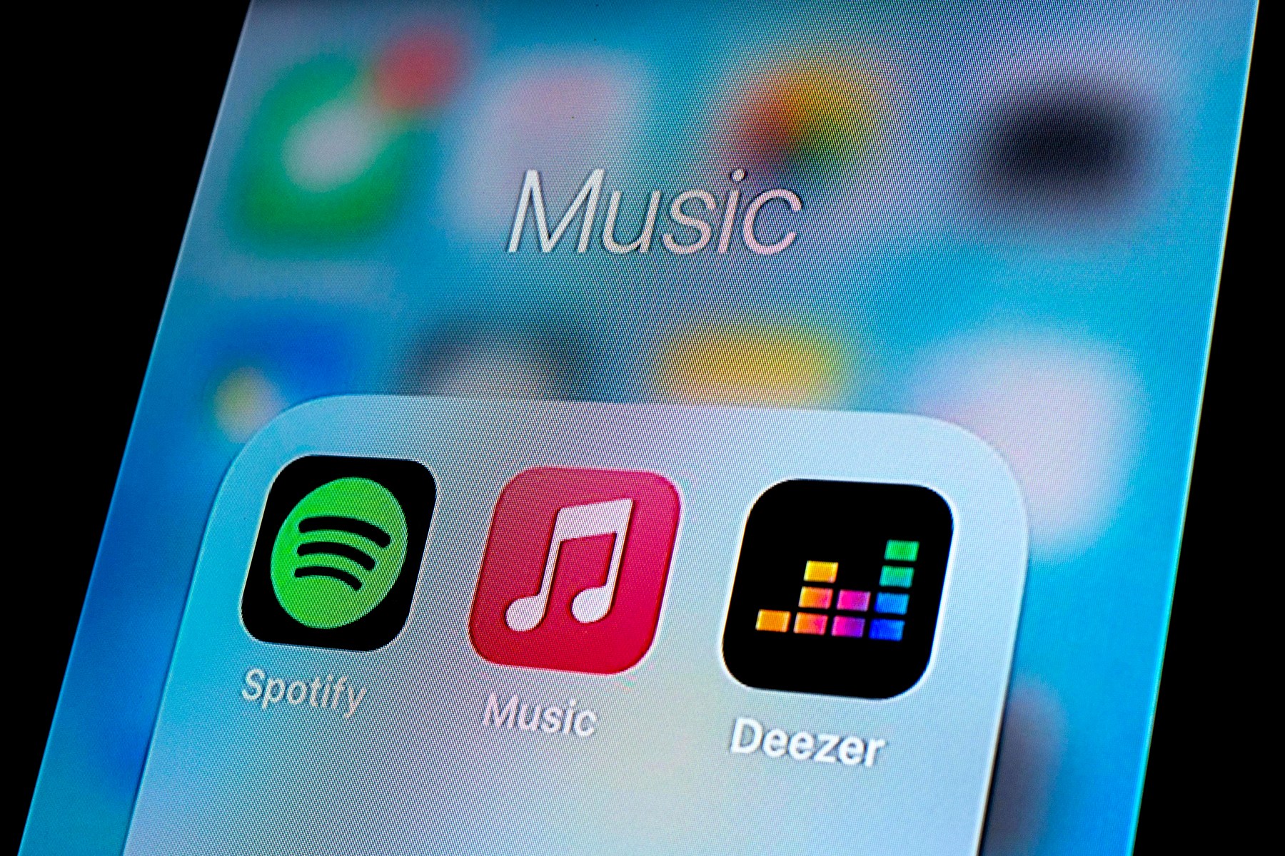 In this photo illustration, a Spotify app, Apple Music app and Deezer app are seen displayed on a smartphone.