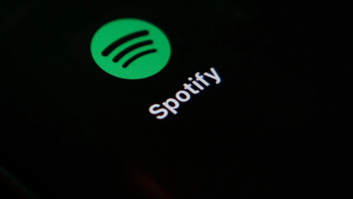 Spotify logo and wordmark glowing on a dark screen.