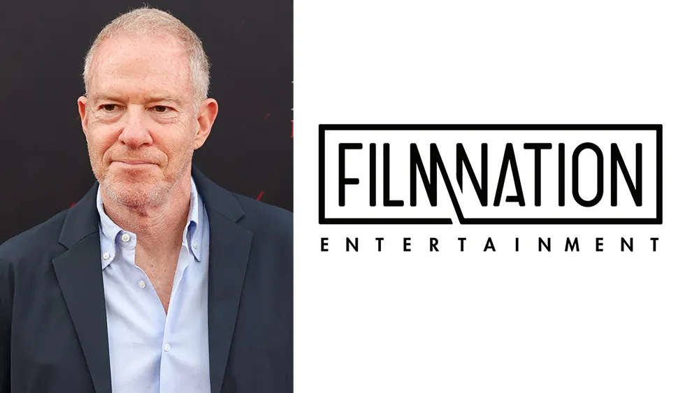 A man in a dark blazer beside the FilmNation Entertainment logo on a white background.