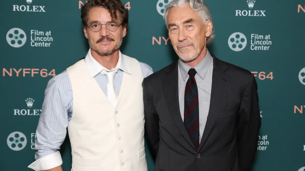 Two men in dress clothes pose before a teal backdrop with Rolex and Film at Lincoln Center logos.