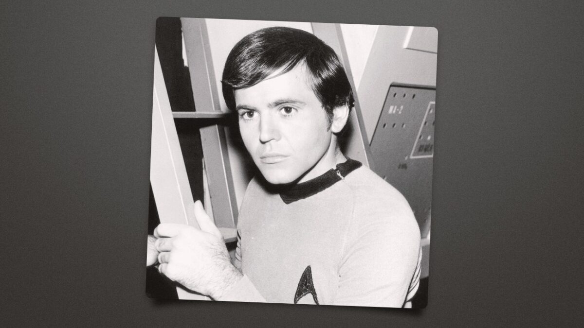 A black-and-white portrait shows a young man in a uniform holding a vertical railing.