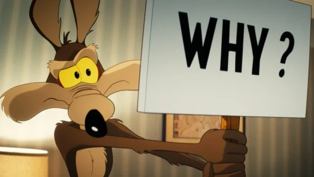 Cartoon coyote with yellow eyes holds a large white sign reading “WHY?”